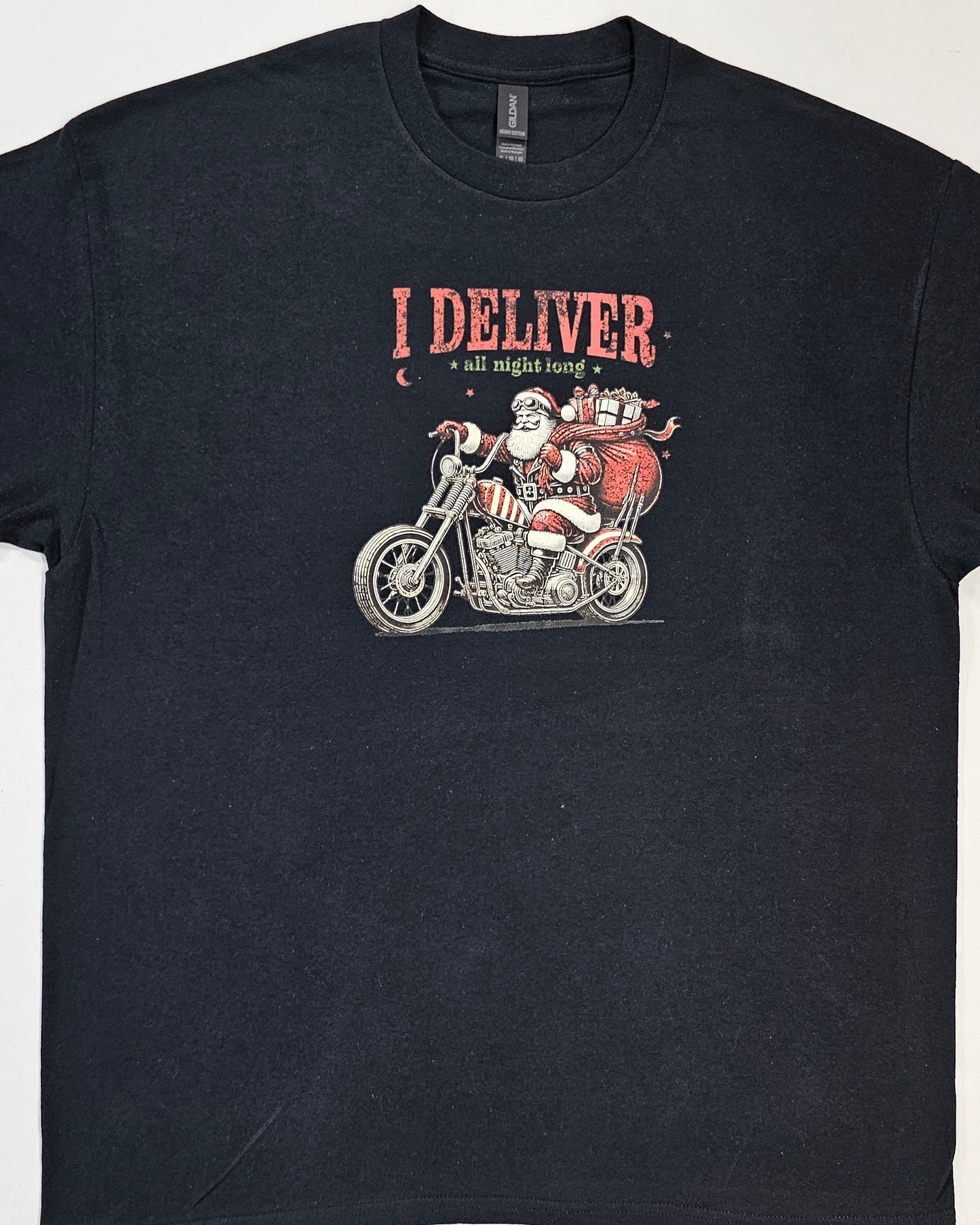 Black t-shirt with a graphic of Santa delivering gifts on a motorcycle and text 'I Deliver all night long' on a white background.