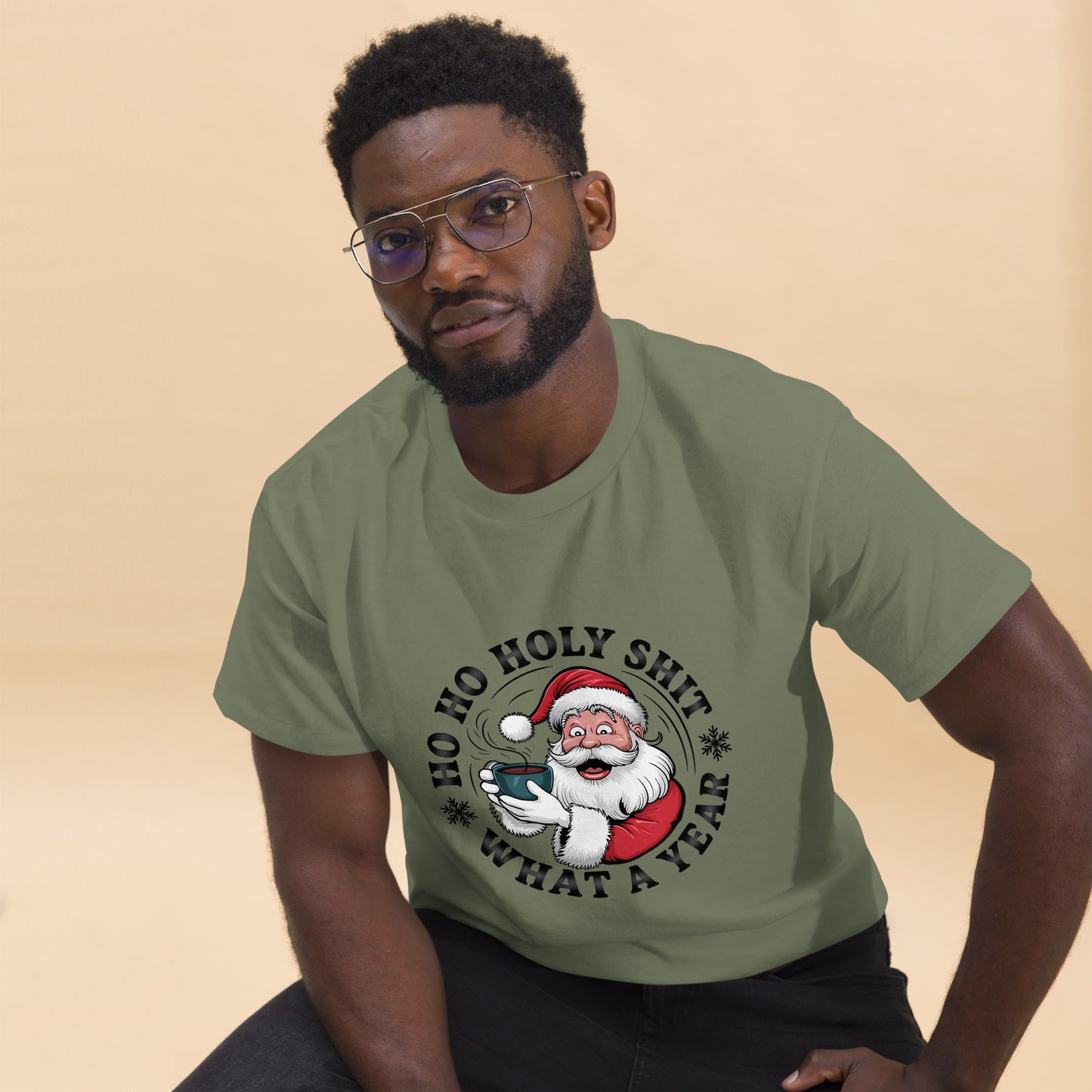 Man wearing a green t-shirt with a Christmas-themed graphic and text.