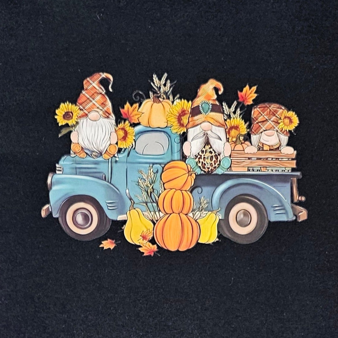 Black t-shirt with a colorful graphic of a truck and fall-themed elements on a white background
