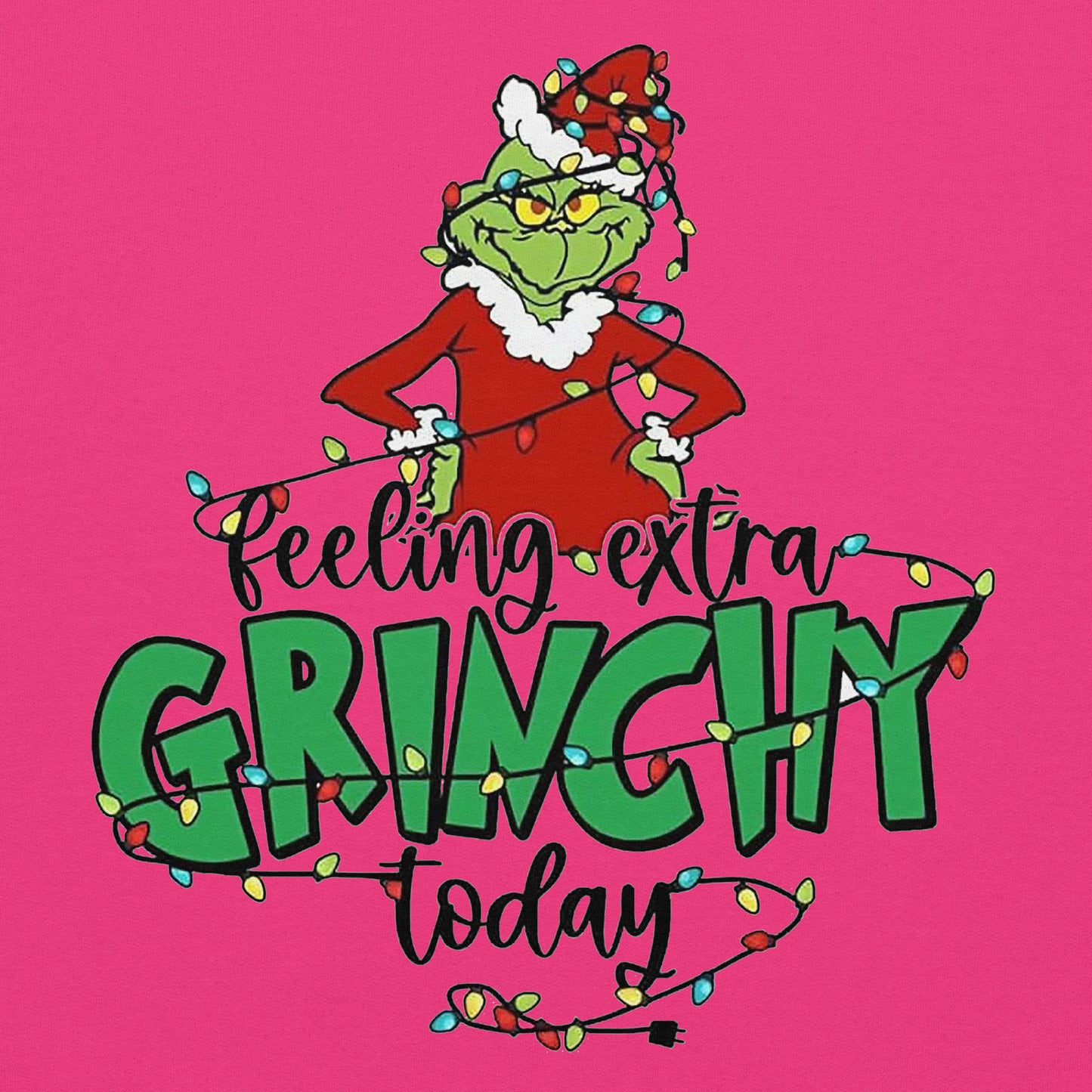 Cartoon character wearing a red suit with white fur trim and green hat, surrounded by Christmas lights on a pink background with text 'Feeling extra Grinchy today'.