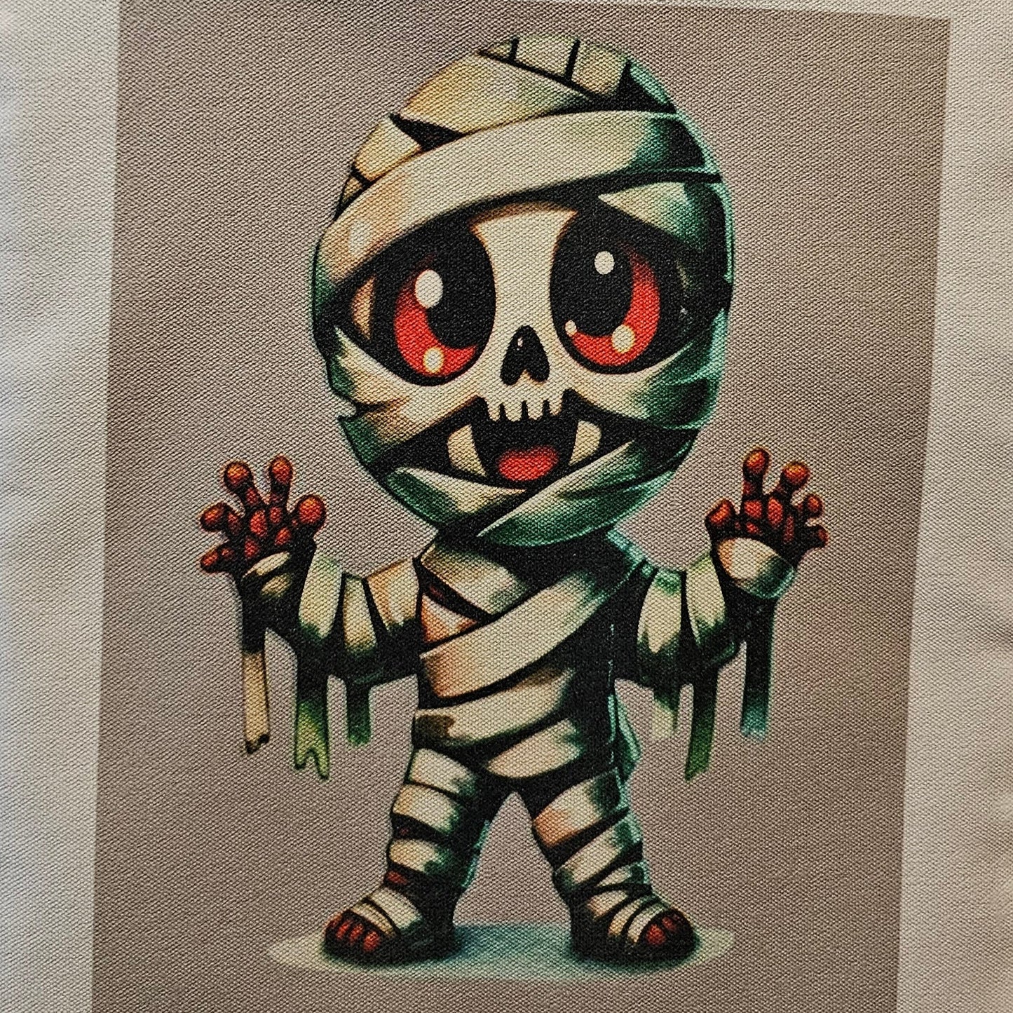 Decorative tote with a cartoonish mummy design on a neutral background