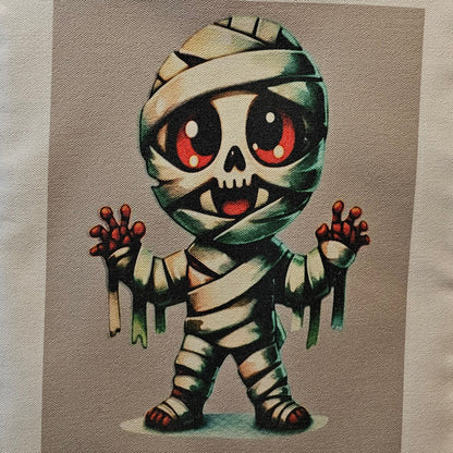 Decorative tote with a cartoonish mummy design on a neutral background
