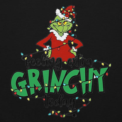 Grinch character with Christmas lights and text 'Feeling extra Grinchy today' on a black background