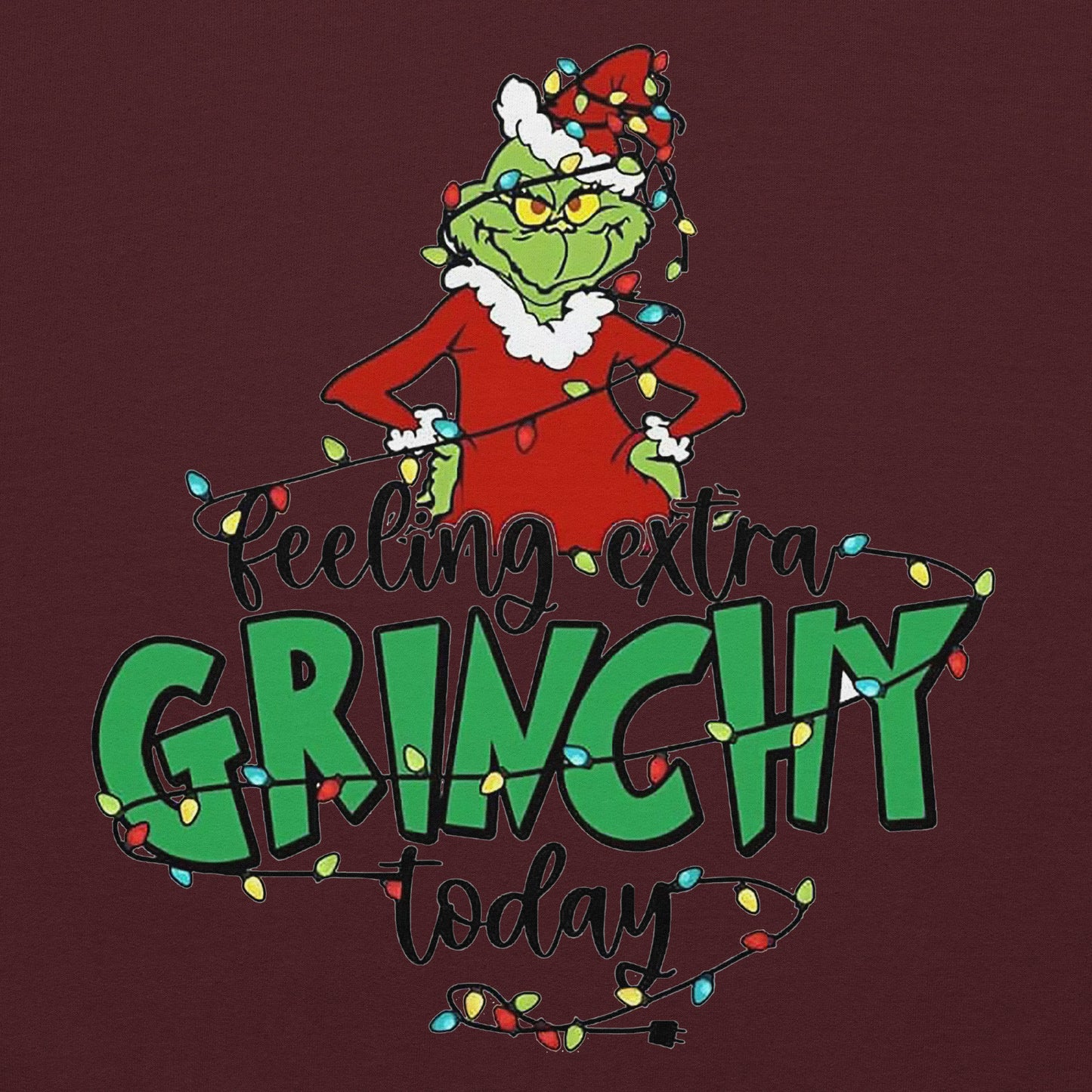 Grinch character with Christmas lights and text 'Feeling extra Grinchy today' on a dark red background