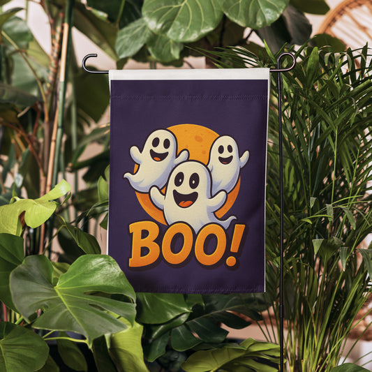 Halloween-themed garden flag with ghosts and 'BOO!' text hanging among plants.