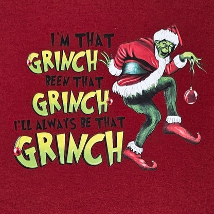 Red t-shirt with Grinch graphic and text on a white background