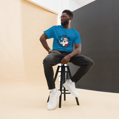 Man sitting on a stool wearing a blue t-shirt with a graphic design.