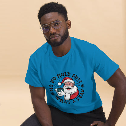 Man wearing a blue t-shirt with a graphic design of Santa Claus and text on a beige background
