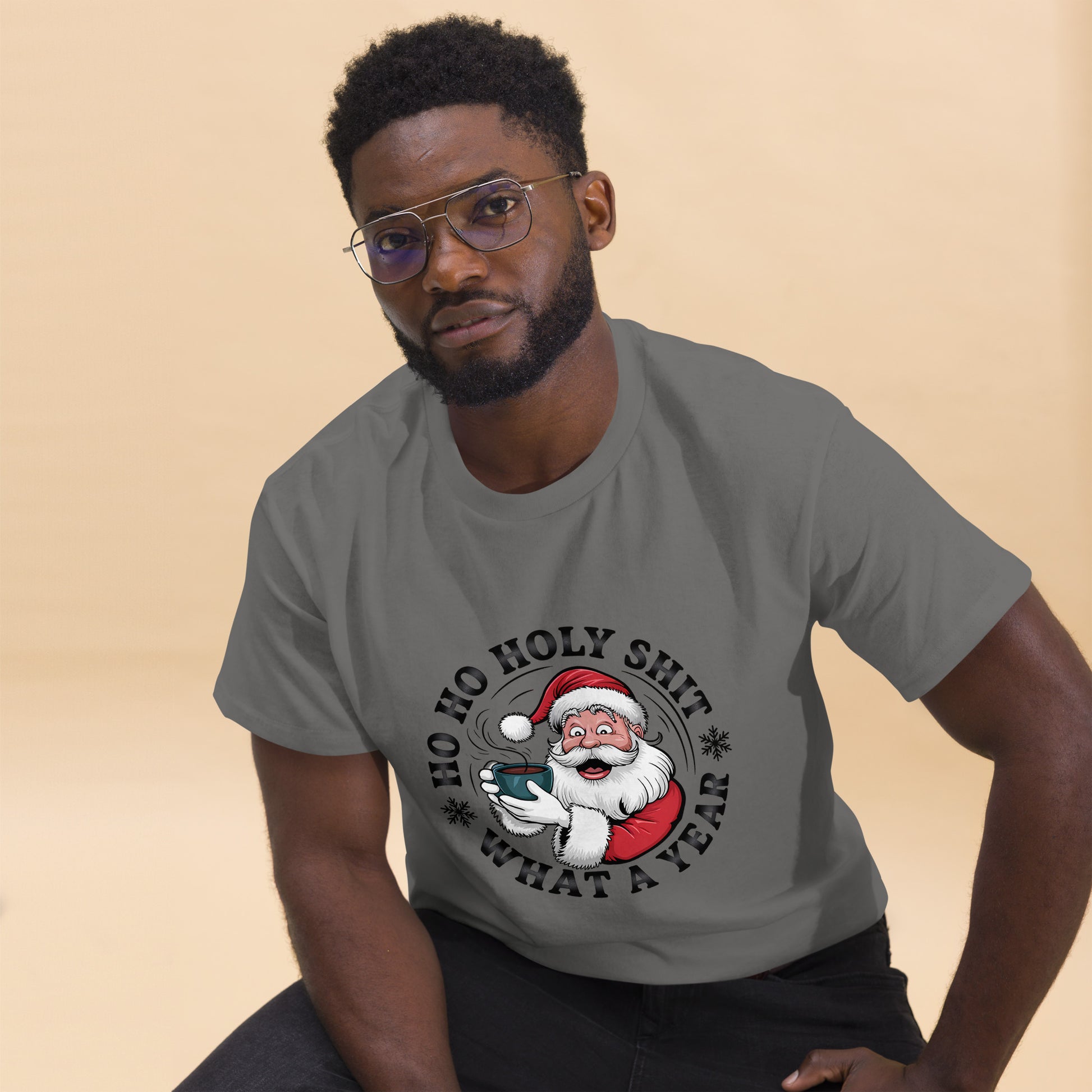 Man wearing a gray t-shirt with a Santa Claus graphic and text on a beige background