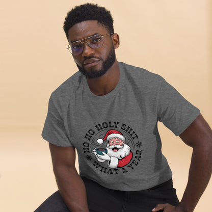 Man wearing a gray t-shirt with a graphic of Santa Claus and text on a beige background