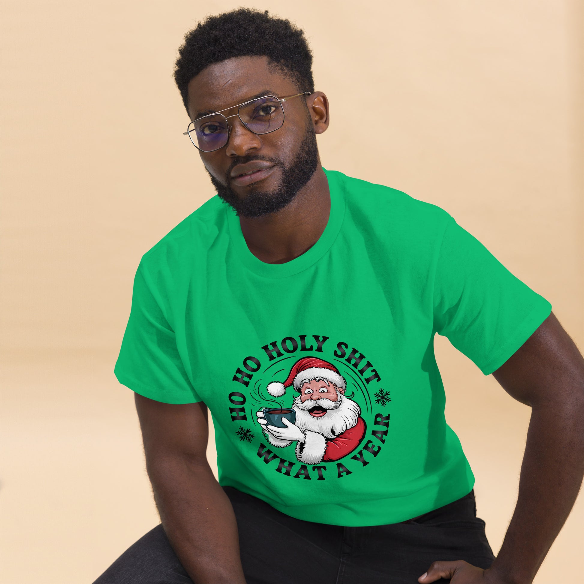 Man wearing a green t-shirt with a Christmas-themed graphic and text.