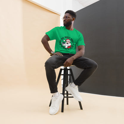 Man sitting on a stool wearing a green t-shirt with a graphic design.