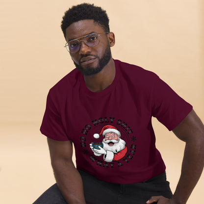 Man wearing a maroon t-shirt with a Christmas-themed graphic on a beige background