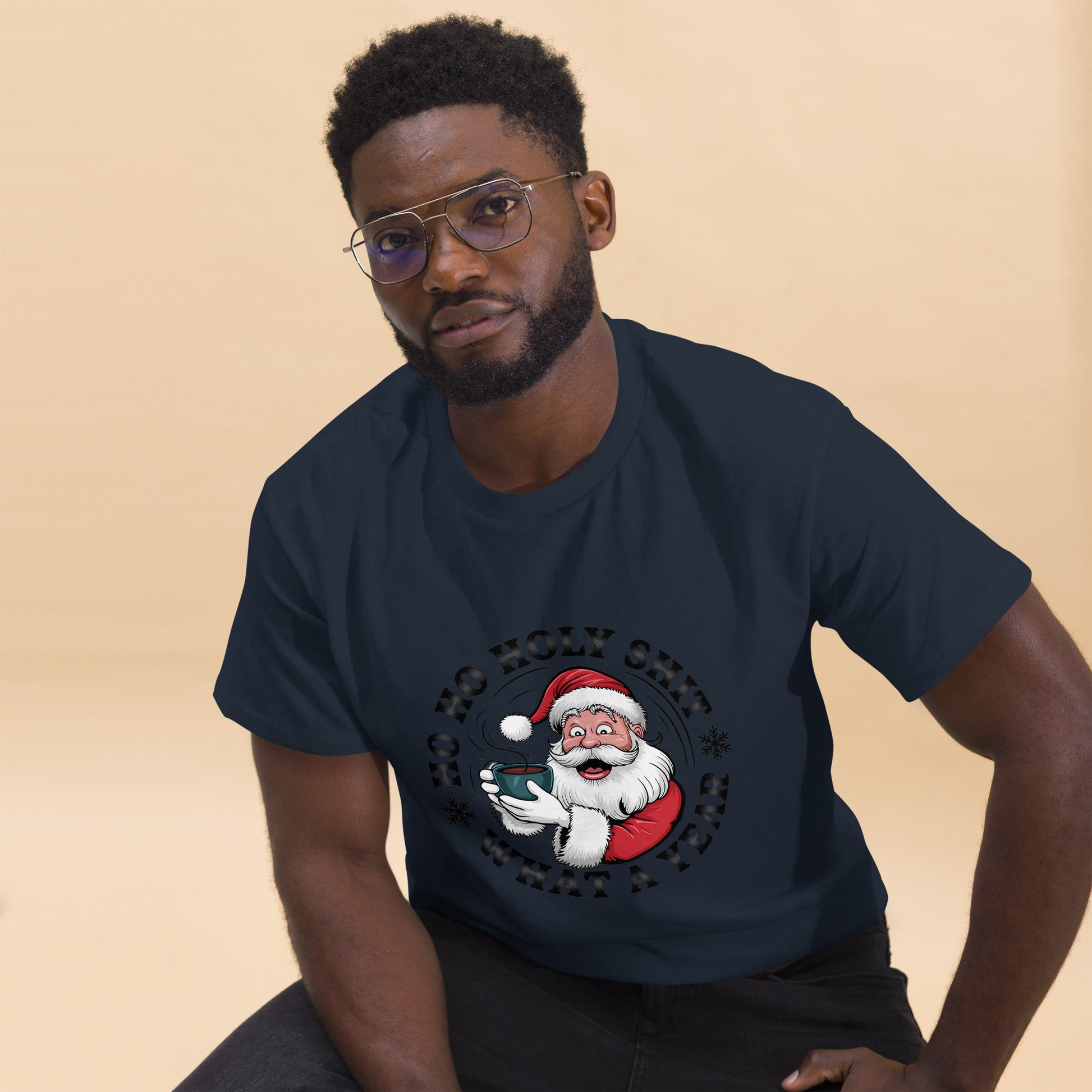 Man wearing a navy blue t-shirt with a Santa Claus graphic on a beige background