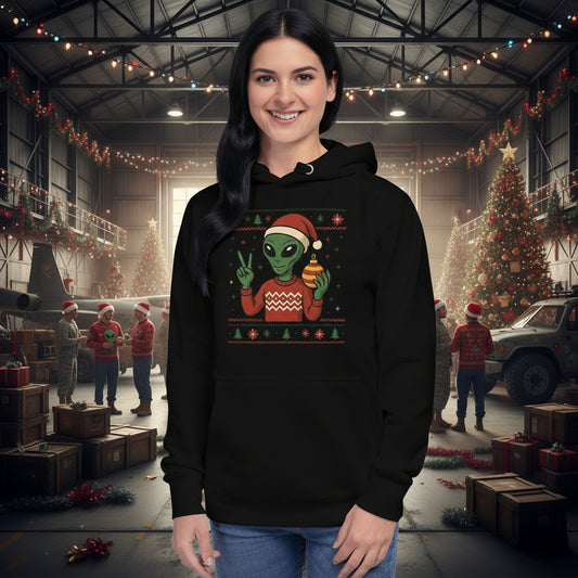 Person wearing a black hoodie with a Christmas-themed alien design on a white background