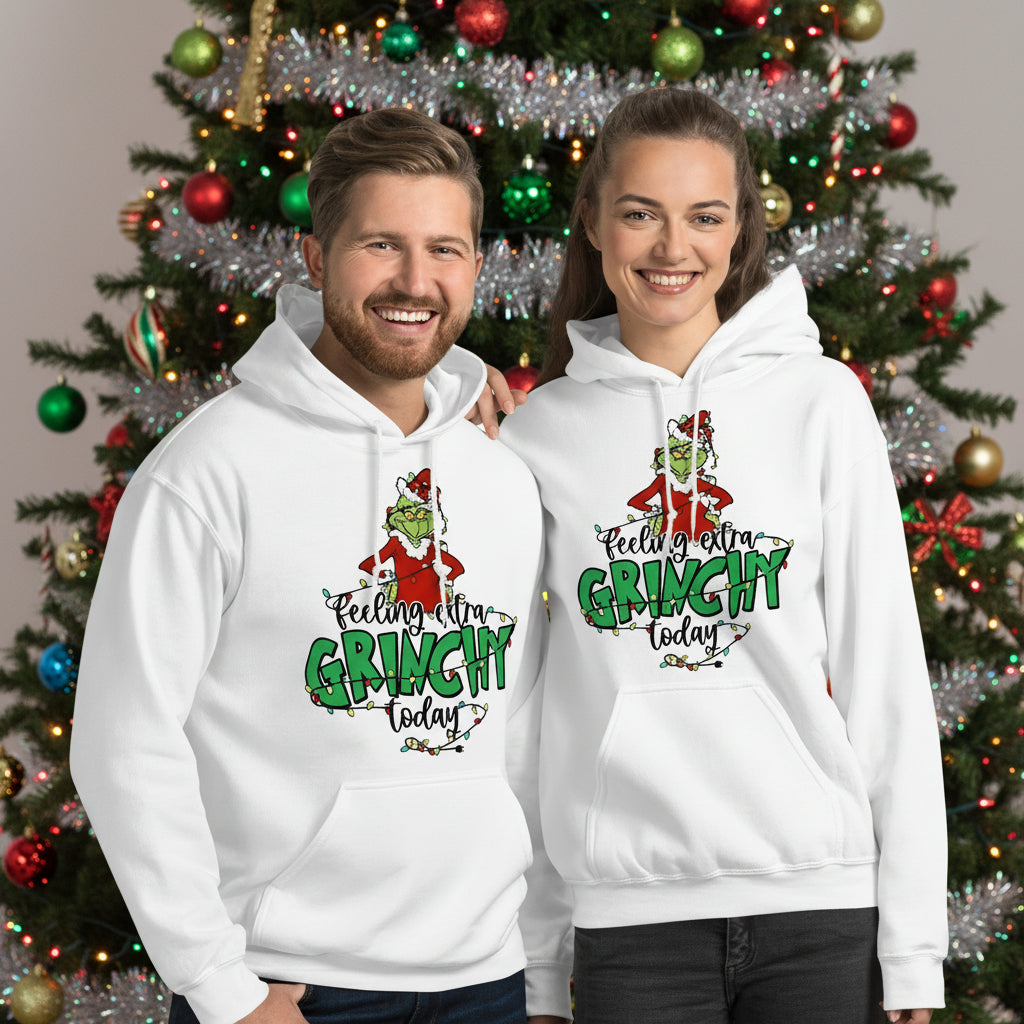 Two people wearing black hoodies with 'Grinch' design and text.