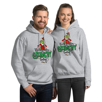 Two people wearing gray hoodies with a Grinch design and text.