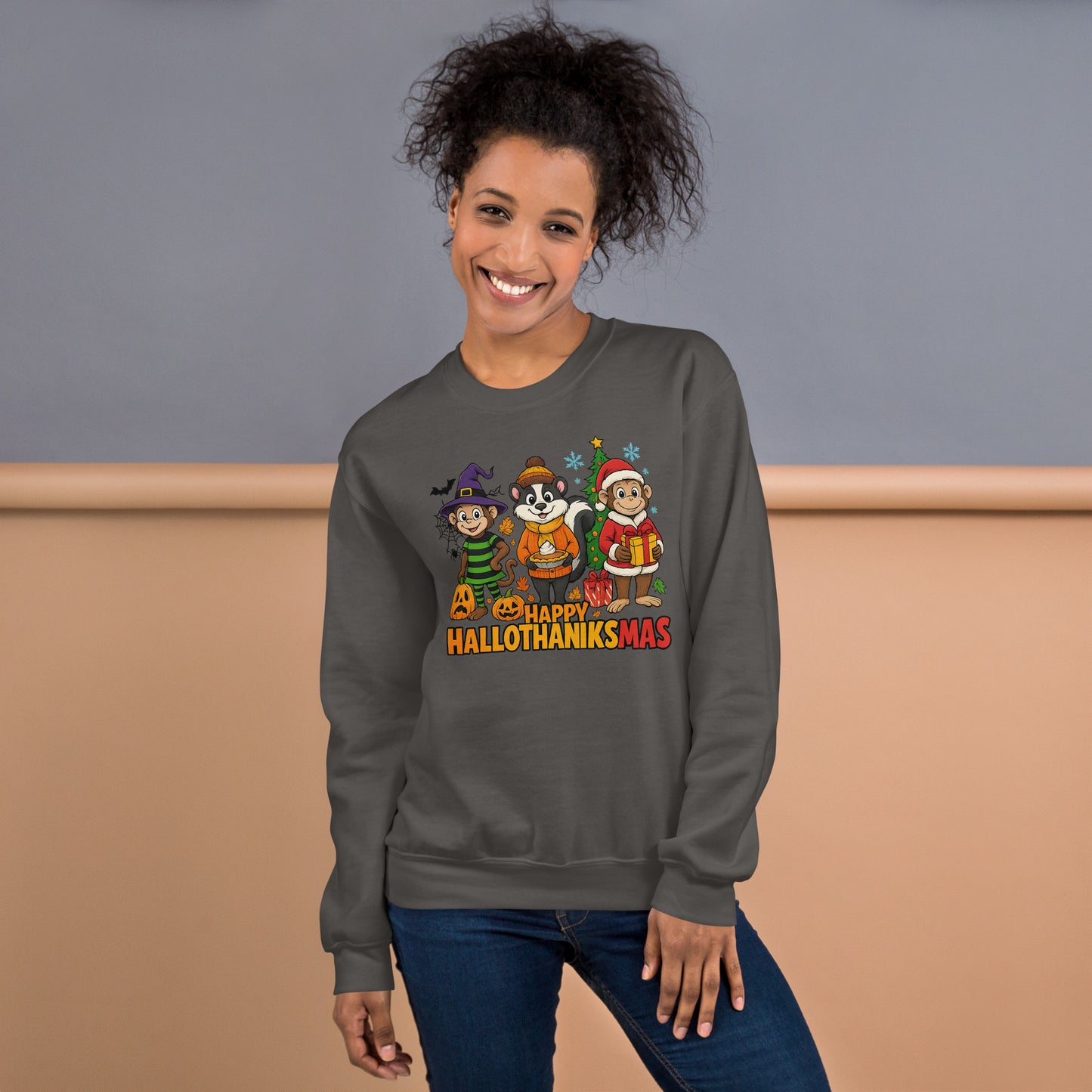Person wearing a gray sweatshirt with 'Happy Hallothanksmas' design against a beige and gray background