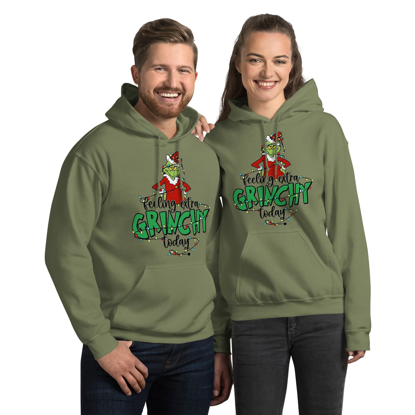 Two people wearing green 'Feeling extra Grinchy today' hoodies on a white background