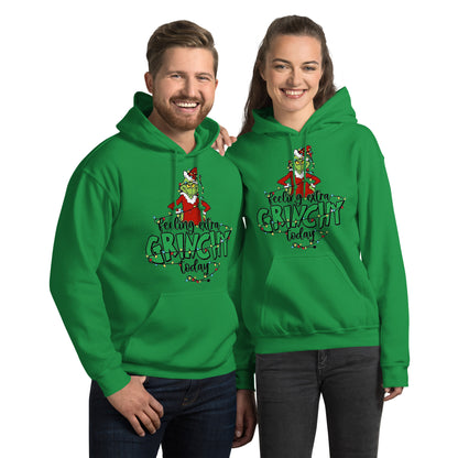 Two people wearing green hoodies with a Christmas-themed design on a white background