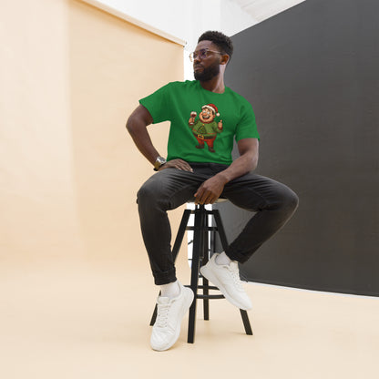 Man sitting on a stool wearing a green t-shirt with a graphic design, black pants, and white sneakers.