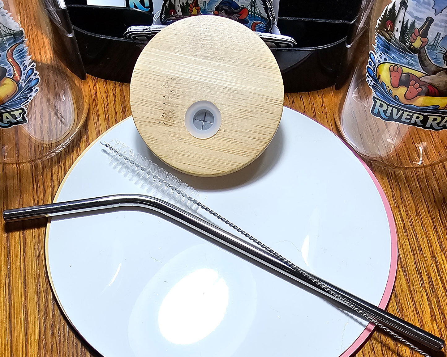Close-up of a metal straw and a bamboo wooden lid.