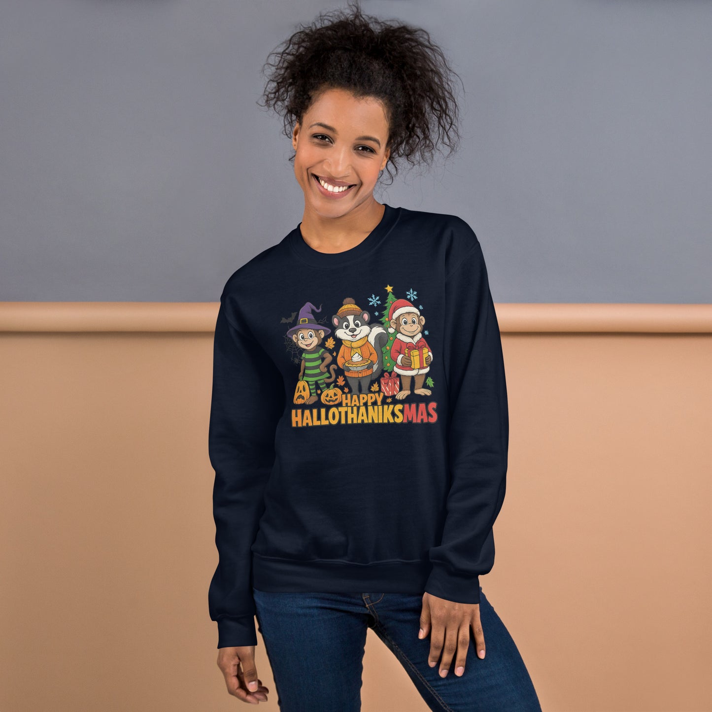 Person wearing a navy sweatshirt with 'Happy Hallothanksmas' design, standing against a beige and gray background.