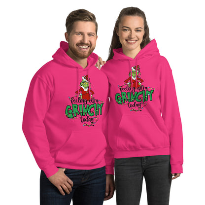Two people wearing pink 'Feeling extra Grinchy today' hoodies on a white background