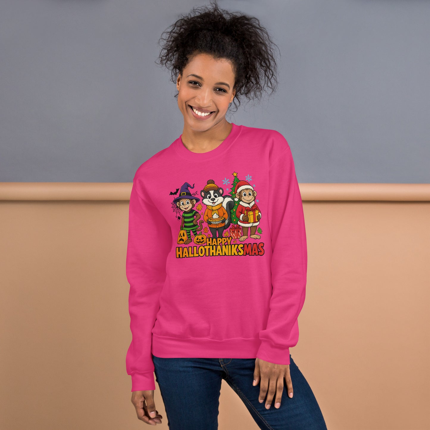 Person wearing a pink sweatshirt with 'Happy Hallothanxmas' design against a plain background
