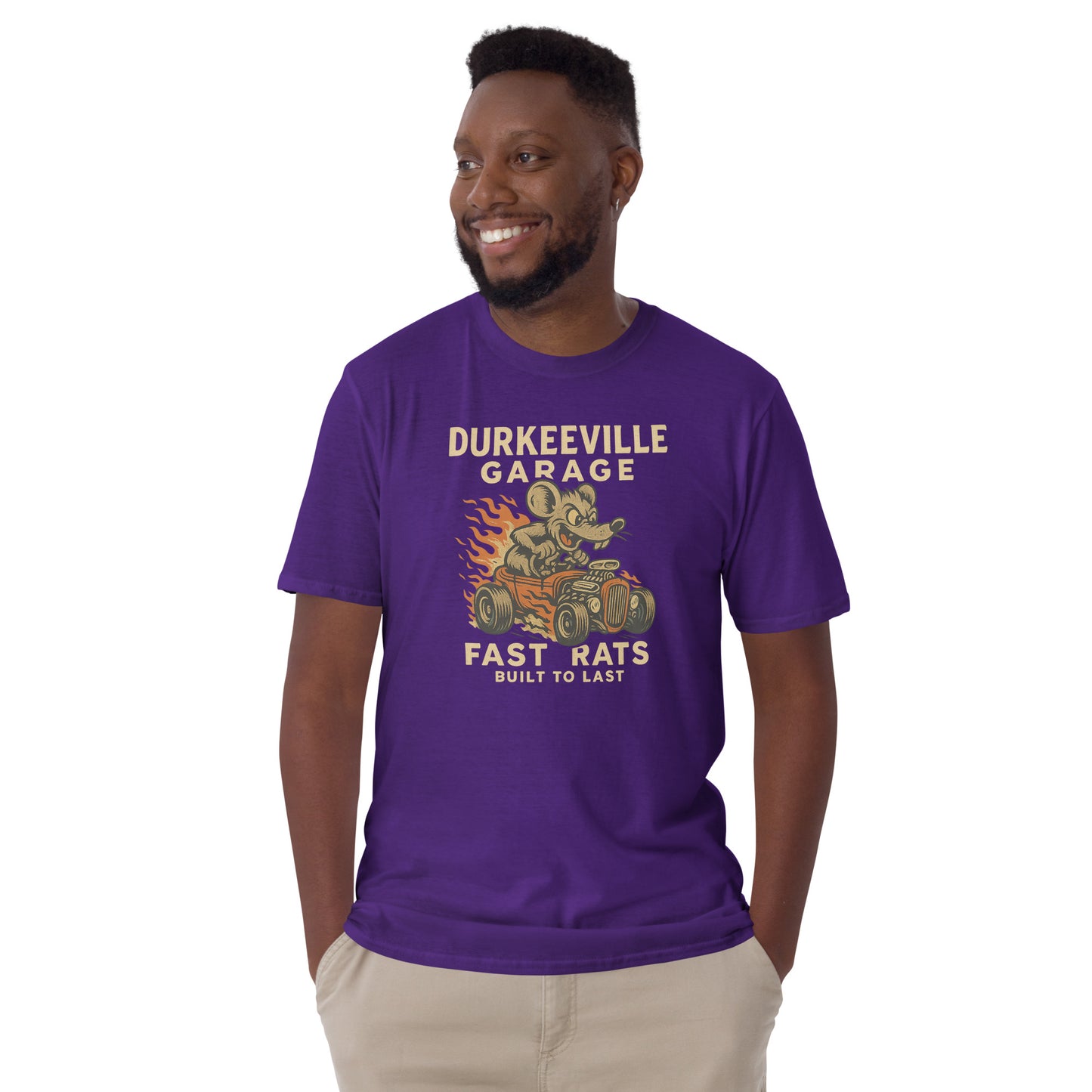 Man wearing a purple t-shirt with 'Durkeeville Garage Fast Rats' graphic design on a white background