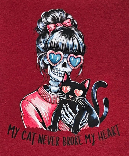 Maroon t-shirt with a graphic of a skeleton holding a cat and text on a white background