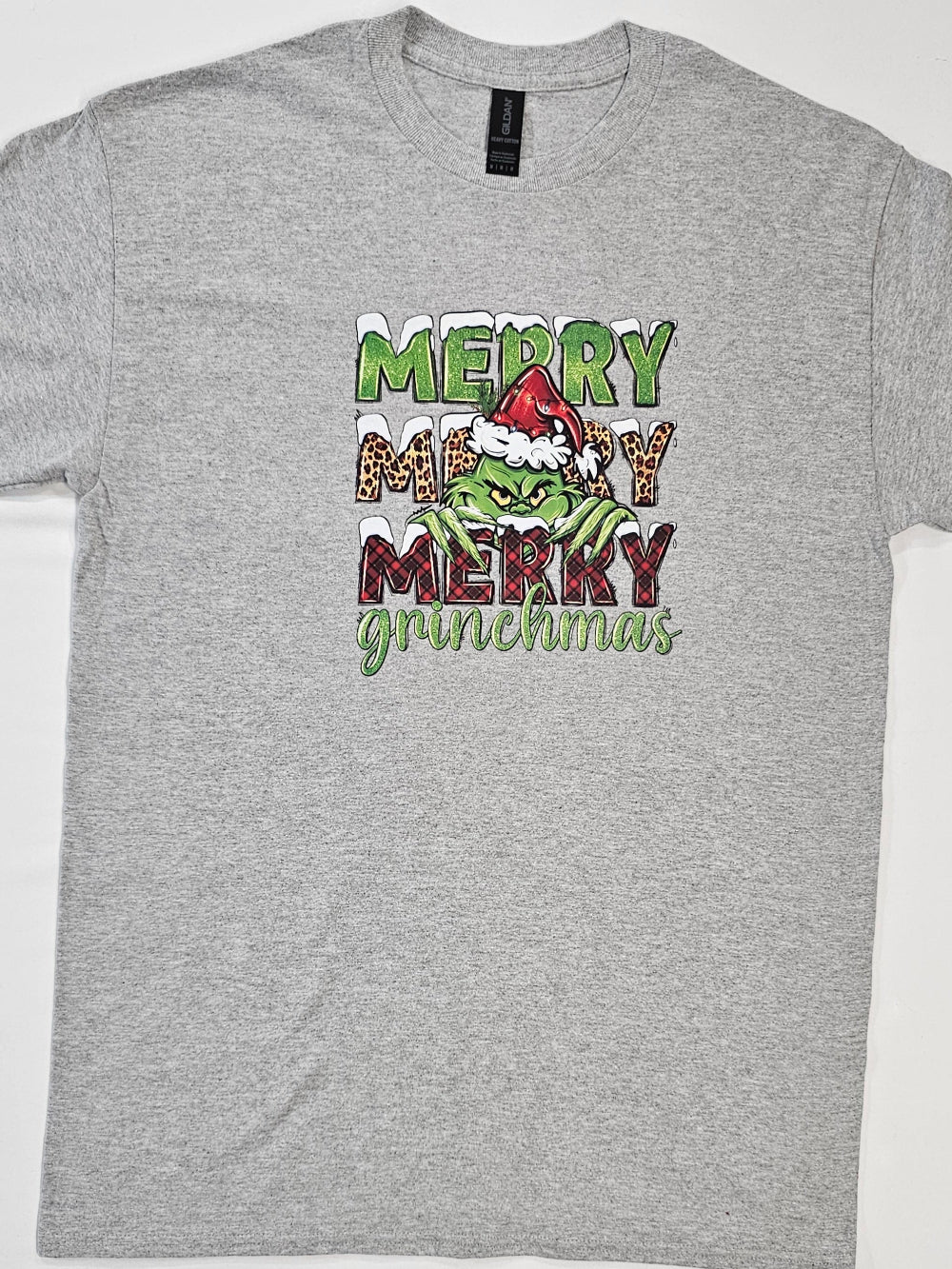 Gray t-shirt with 'Merry Grinchmas' graphic design on a white background