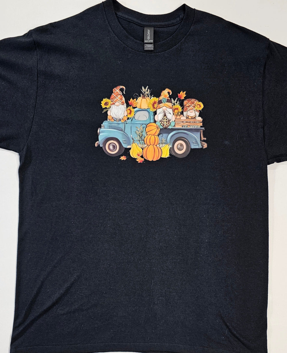 Black t-shirt with a colorful graphic of a truck and autumn elements on a white background